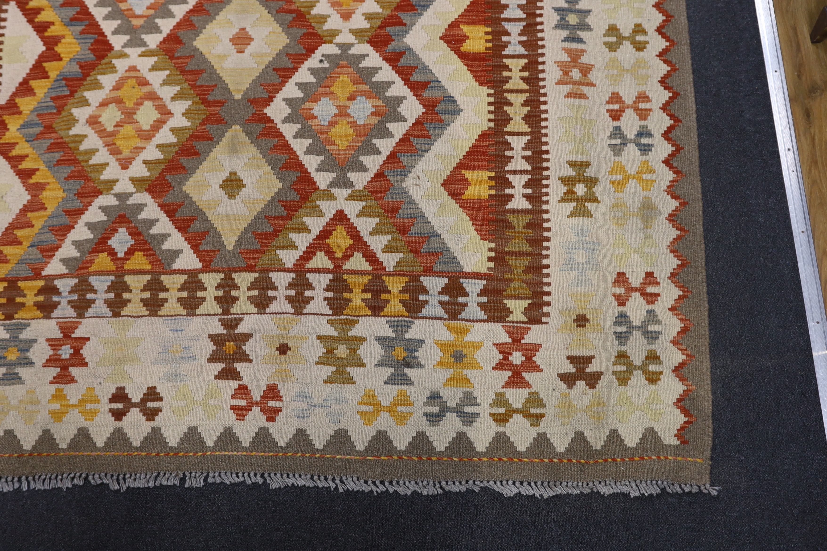 A Kilim polychrome geometric carpet, 250 x 177cm